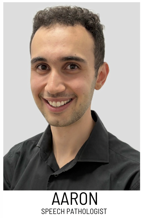 Portrait of Aaron, a speech pathologist, smiling in a black shirt against a light background (professional headshot).