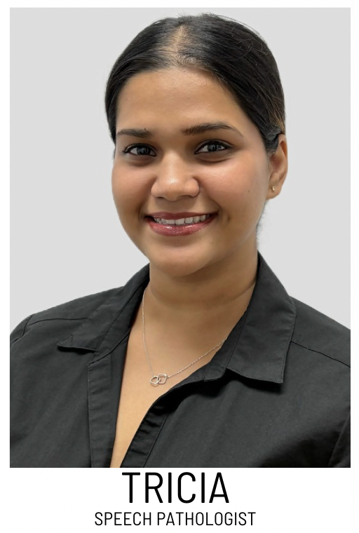 Portrait of Tricia, a speech pathologist, smiling in a dark blouse.