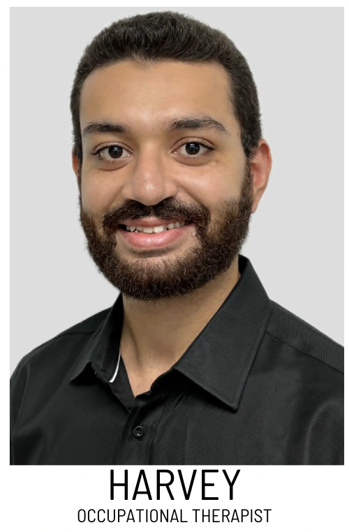 Portrait of Harvey, an occupational therapist, smiling in a dark collared shirt on a white background.
